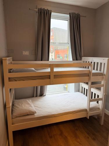 a bunk bed in a room with a window at Hostel & home Marlborough street in Dublin