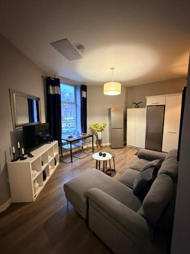 a living room with a couch and a table at Hostel & home Marlborough street in Dublin