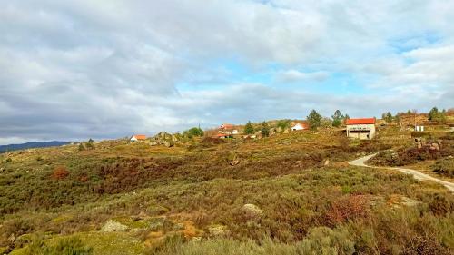 a house on the side of a hill with a road at Quinta da Estrela in Ponte Nova