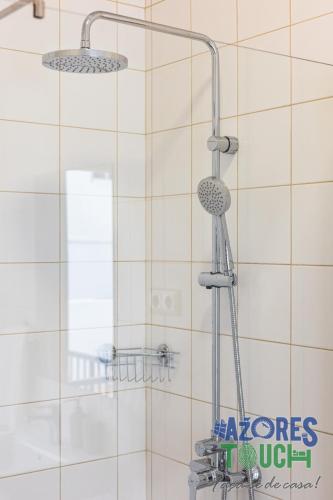 a shower in a bathroom with two shower heads at Hostel Casa São Pedro in Angra do Heroísmo