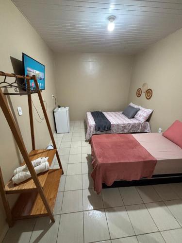 a bedroom with two beds and a ladder in it at Pousada Caribe Amazônico Alter do Chão - 1 quarteirão da Orla de Alter in Alter do Chao