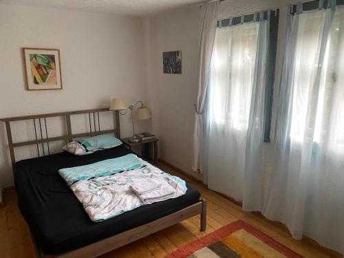 a bedroom with a bed and a window with curtains at Schöne Tage im Denkmal in Bittstädt