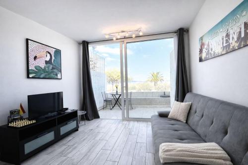 a living room with a couch and a television at Oasis Costa del Silencio - Large Pool & Relax in Costa Del Silencio