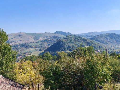 a view of a valley with trees and mountains at B&B 3B Cavriana in San Valentino