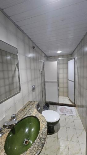 a bathroom with a green sink and a toilet at Hotel Casa Blanca - Adults Only in Rio de Janeiro