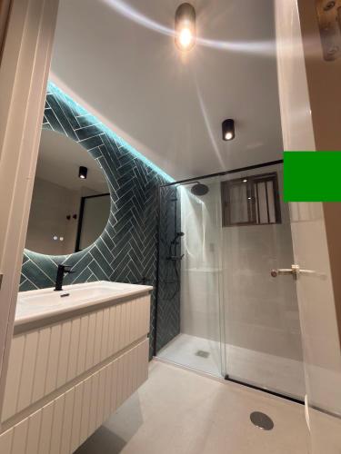 a bathroom with a shower and a sink and a mirror at PLAYA Y PISCINA Intiyan PONDOS in Almuñécar