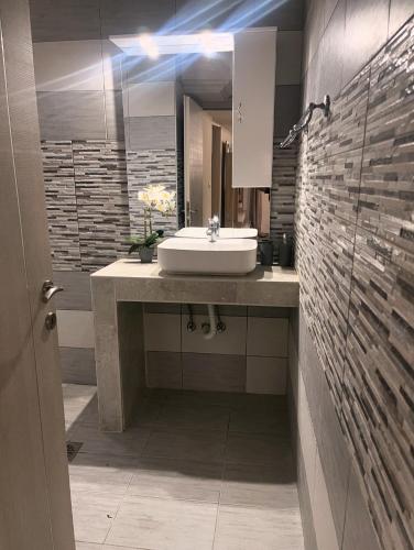 a bathroom with a sink and a mirror at Villa Oasis 3 in Kalithies