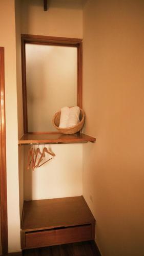 a bathroom with a mirror and a basket on a shelf at Hotel Jardin Boutique rodadero in Santa Marta