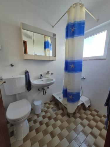a bathroom with a toilet and a sink at Orebic BnB in Orebić