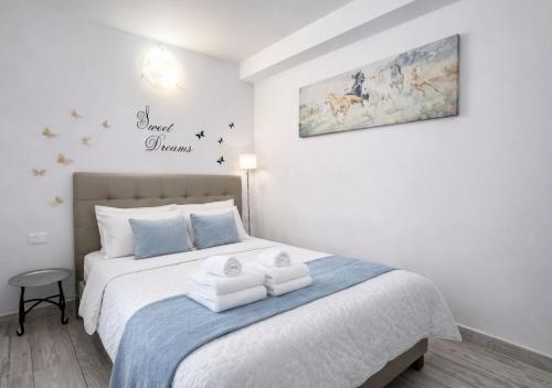 a bedroom with a bed with two folded towels on it at Oasis Costa del Silencio - Large Pool & Relax in Costa Del Silencio