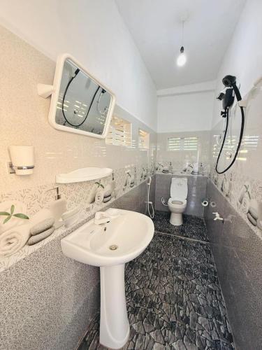 a bathroom with a sink and a toilet at Lumora - Midigama in Midigama East