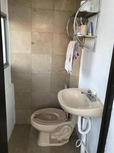 a bathroom with a toilet and a sink at La casa flores in Atlixco