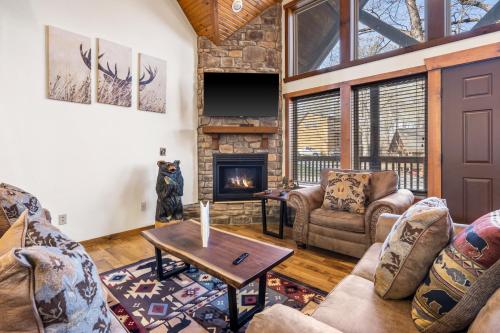 a living room with couches and a fireplace at Cozy 'Rustic River Lodge' Near SDC with Pools! in Branson