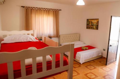 a bedroom with two beds and a mirror at Hotel Blu Mare Shengjin in Shëngjin
