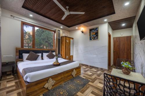 a bedroom with a large bed in a room at Hotel Elegant Dreamscape Kasauli by Splendid Retreat Hotels in Kasauli