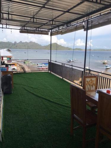 a balcony with a view of the water at Homestay Jifiqa komodo in Komodo