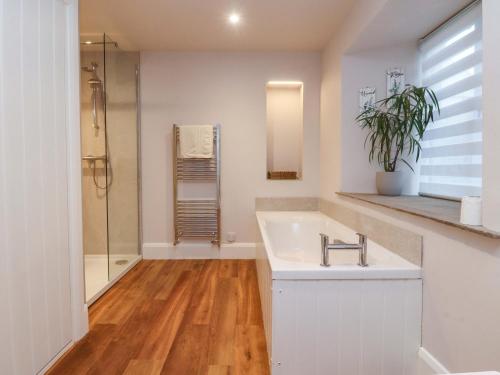 a bathroom with a sink and a shower at Cobble Cottage in Clitheroe