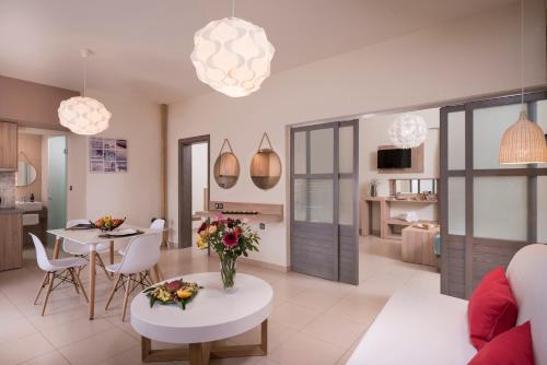 a kitchen and living room with a table and chairs at Sea & City Apartments in Chania Town