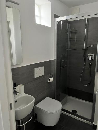 a bathroom with a shower and a toilet and a sink at Via privata in Lugano