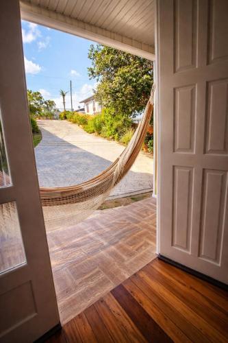 a door leading to a hammock in a house at ROTA DA SERRA casa completa com ar-cond in Orleans