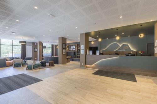 a lobby with a reception desk in a building at Résidence Odalys L'Ecrin de Vars in Vars