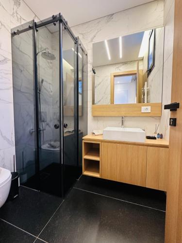 a bathroom with a shower and a sink at La Villa Kfardebian Stone Villa in Fārayyā
