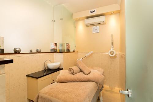 a small bathroom with a sink and a mirror at Coopmanhuijs Boutique Hotel & Spa in Stellenbosch