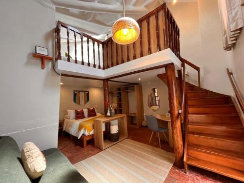 a bedroom with a staircase and a bed in a room at Casa Terra Cusco in Cusco
