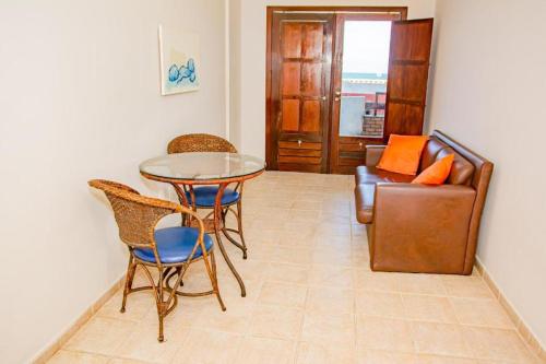 a living room with a table and chairs and a couch at Garbos Soleil Hotel in Natal