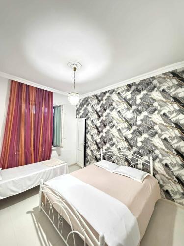a bedroom with two beds and a wall mural at Blue wave in Itʼkhvisi