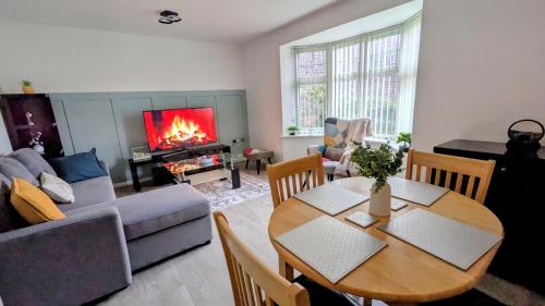 a living room with a table and a couch at Leeds City Junction in Beeston Hill