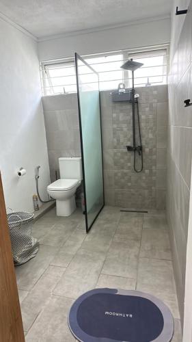 a bathroom with a shower and a mat on the floor at Namastay Apartment - La Gaulette in Rivière Noire