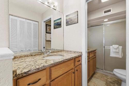 a bathroom with a sink and a shower and a toilet at Bouchelle Island 203 in New Smyrna Beach