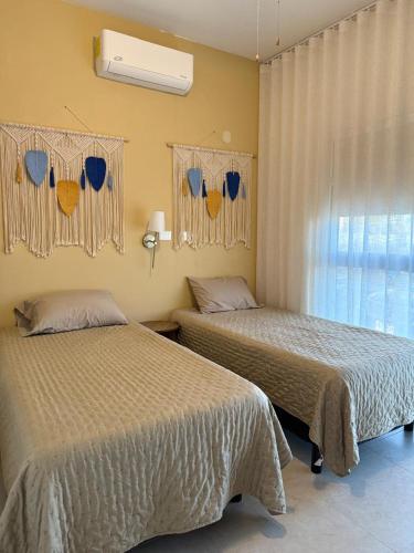 a bedroom with two beds and a window at chema in Cabo San Lucas