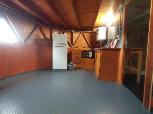 a small kitchen with a refrigerator in a room at Domo Premium in Esquina