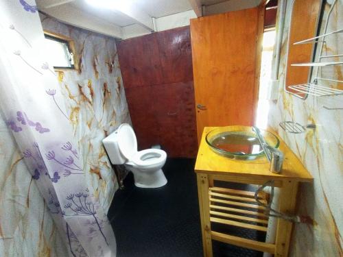 a bathroom with a toilet and a sink at Domo Premium in Esquina