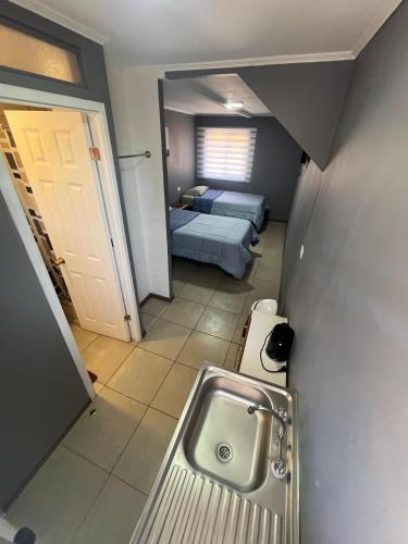 a bathroom with a sink and a bedroom with a bed at Hostal JV Loft Doble B in Nogales