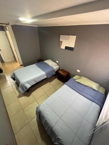 a room with two beds in a room at Hostal JV Loft Doble B in Nogales
