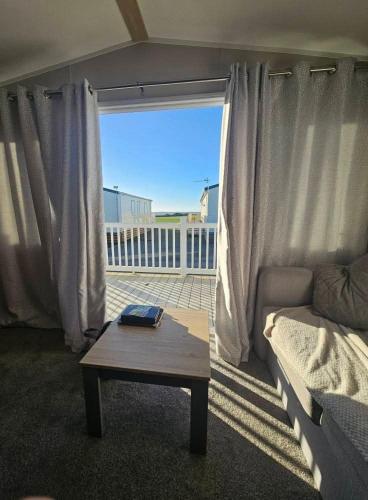 a living room with a couch and a coffee table at Crozzer's Place in Heysham
