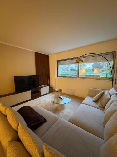 a living room with a couch and a tv at 2BR Retreat in Lumiar near airport w Patio in Lisbon