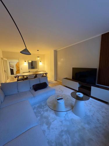 a living room with a couch and a table at 2BR Retreat in Lumiar near airport w Patio in Lisbon