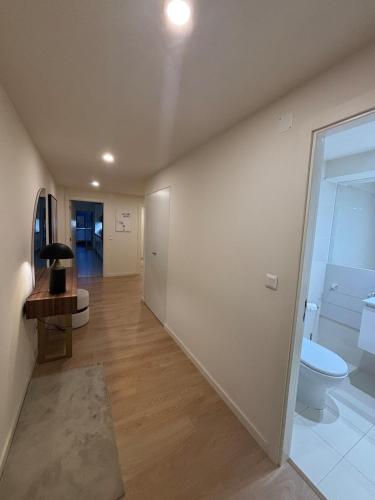 an empty hallway with a toilet and a bathroom at 2BR Retreat in Lumiar near airport w Patio in Lisbon