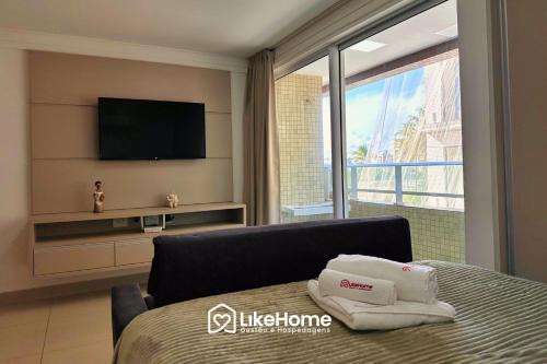 a hotel room with a bed and a television at Mar Bello in Ilha da Restinga