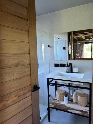a bathroom with a sink and a mirror at KINEKI La Punta - Casa Karen in Brisas de Zicatela