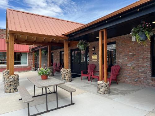 a patio with chairs and a table and a building at Pintler's Portal Hostel in Anaconda