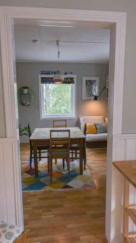 a living room with a table and a couch at Svingen Apartments in Balestrand