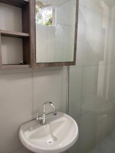 a white sink in a bathroom with a mirror at Casa São Francisco do Sul - #2 in São Francisco do Sul