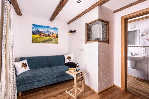 a living room with a couch and a sink at Mayringerlehen in Ramsau