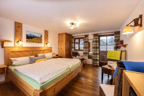 a bedroom with a large bed in a room at Mayringerlehen in Ramsau