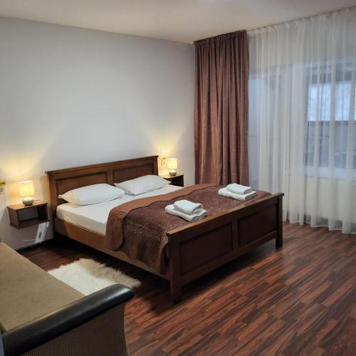 a bedroom with a bed with two towels on it at Conacul de la Dunăre, Eșelnița in Eşelniţa